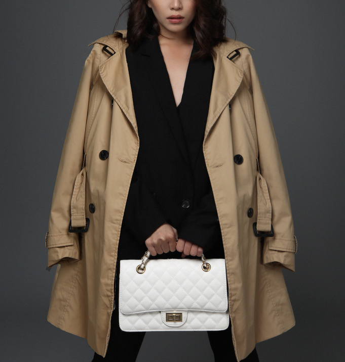Woman In Brown Coat Holding A Bag